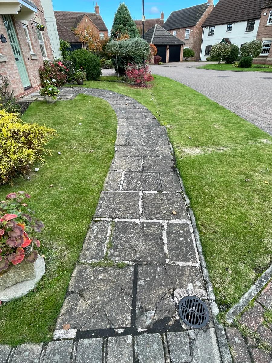 Dirty flagstone path before cleaning